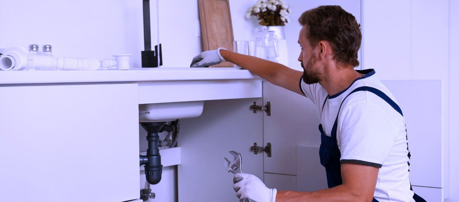 Plumber working on a kitchen sink